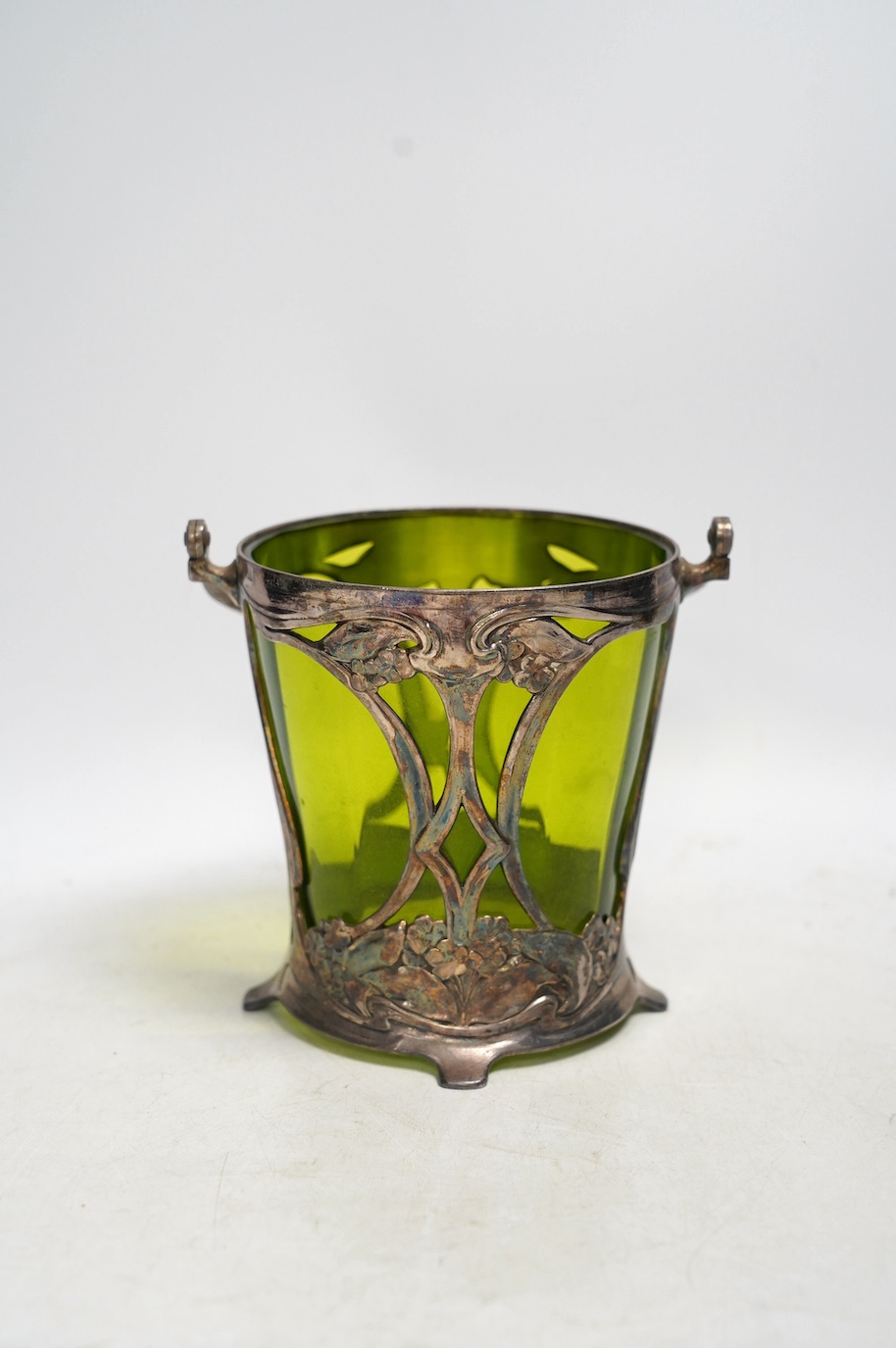 An Art Nouveau WMF pewter mounted biscuit jar with glass liner, lacking cover, stamped to the base, 23cm high including handle. Condition - fair